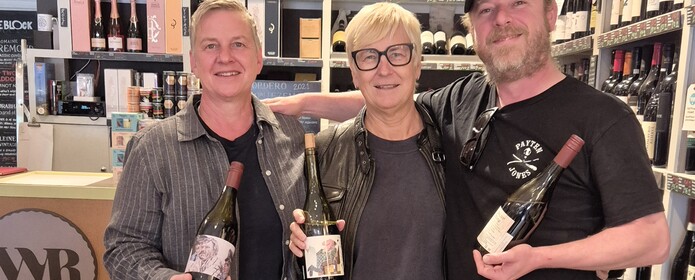 Team at the wine reserve holding up wines from the healesville